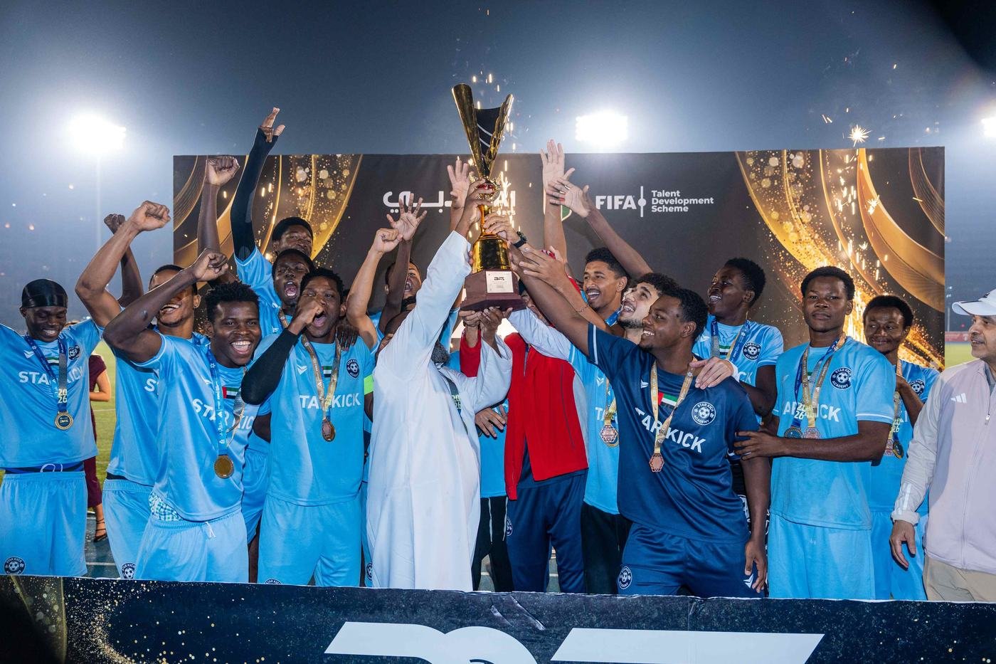 Players celebrating with the trophy