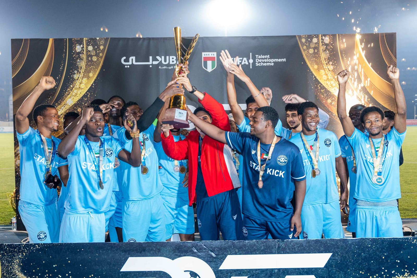Star Kick players lifting the trophy